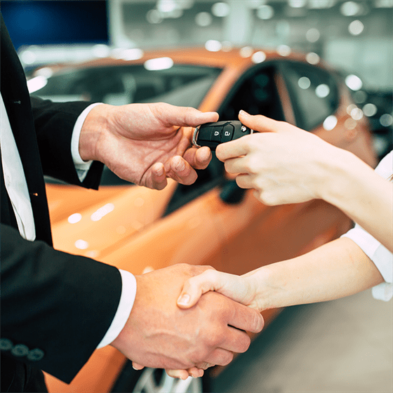 a man shaking hands with a woman in a valet parking service in Houston, TX.