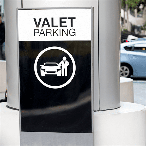 a valet parking sign in front of a building.