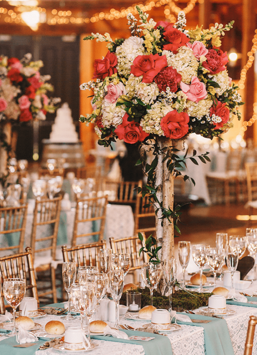 A beautifully decorated table adorned with flowers and greenery, perfect for concierge services in Houston.