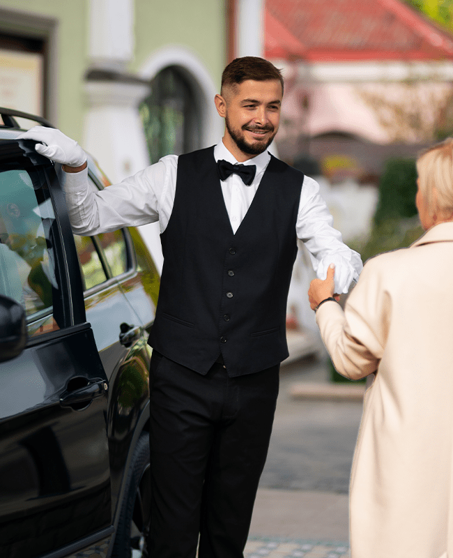 A man providing valet parking services in Houston wearing a vest.